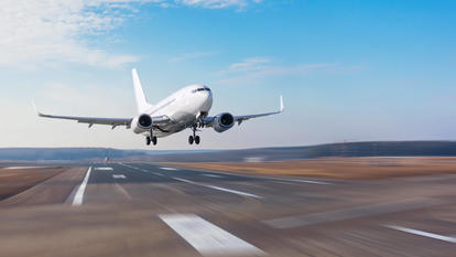 Ein Flugzeug auf einer Startbahn hebt gerade ab.